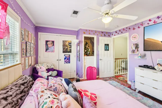 a bedroom with a bed dresser and flat screen tv