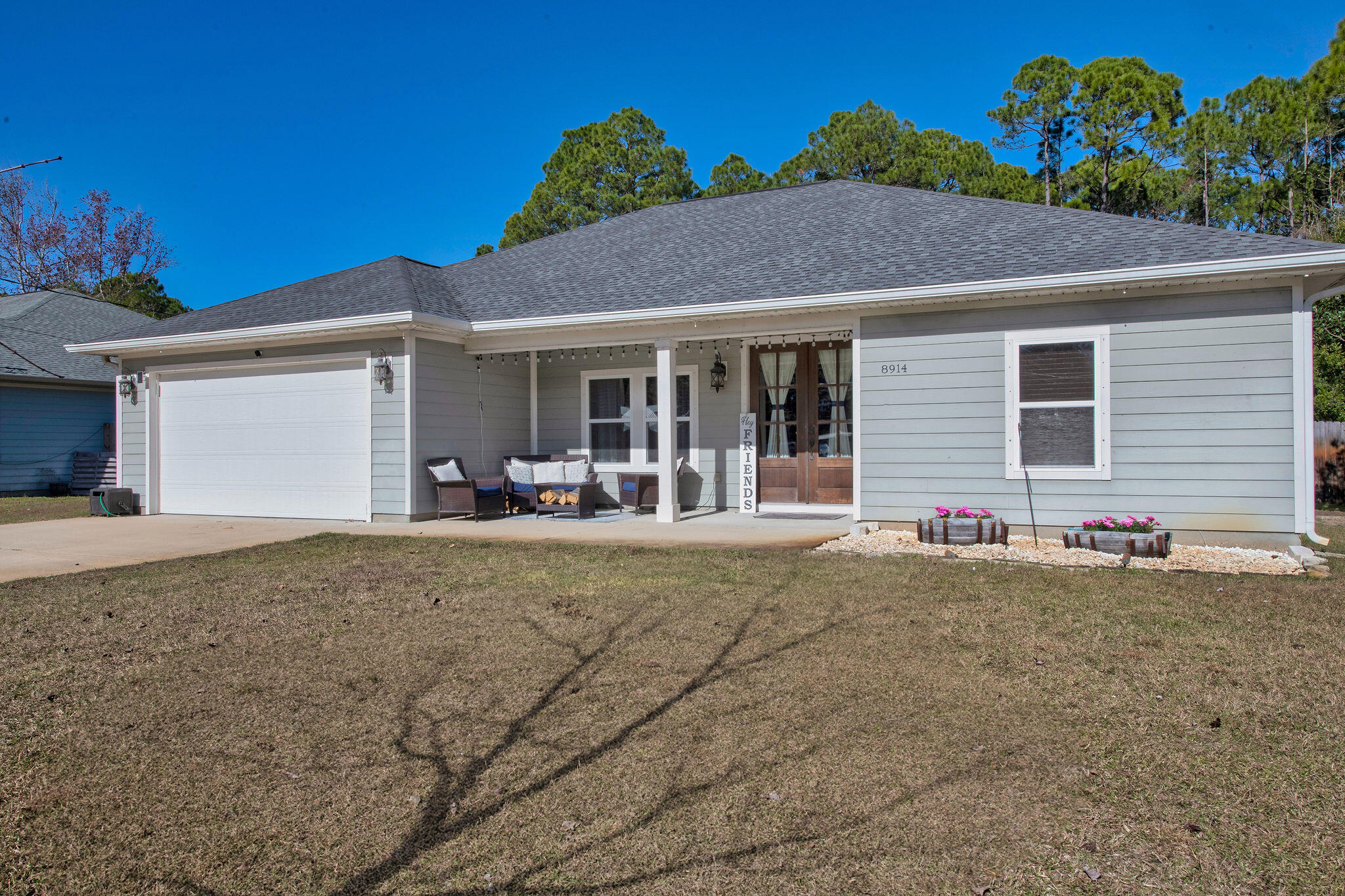 8914 Timber Lane Navarre, FL 32566 - Photo 3 of 40 a view of a house with a backyard and a garage
