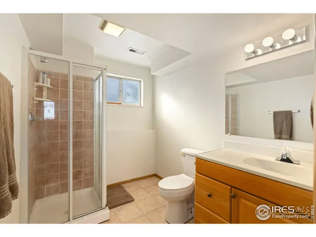 a bathroom with a sink a toilet a shower and a mirror