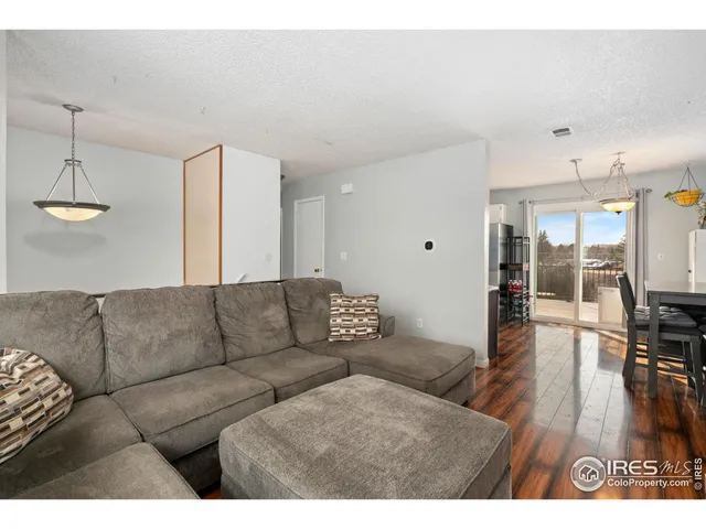 a living room with furniture and kitchen view
