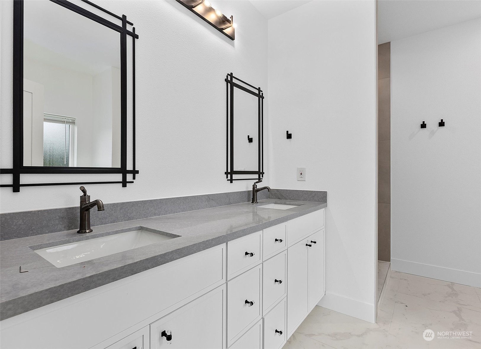 22713 1st Place West Bothell, WA 98021 - Photo 16 of 29 a bathroom with a double vanity sink and a mirror