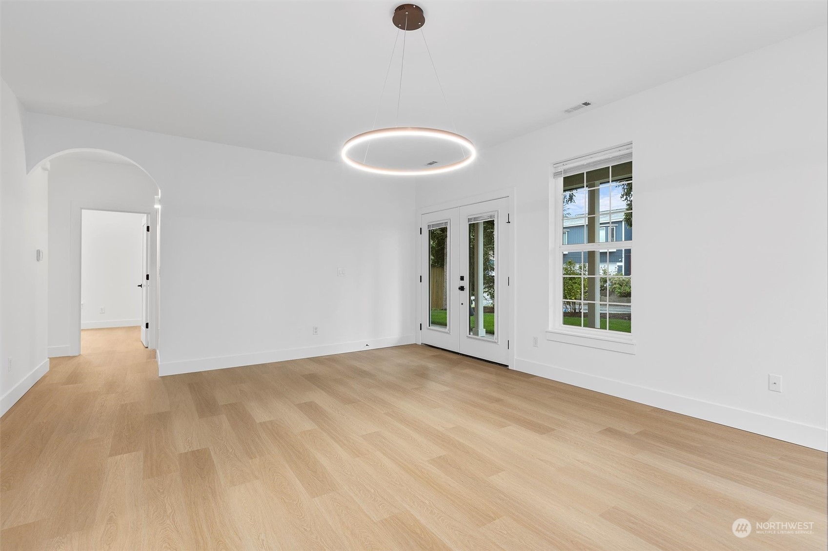 22713 1st Place West Bothell, WA 98021 - Photo 5 of 29 a view of an empty room with a window and wooden floor