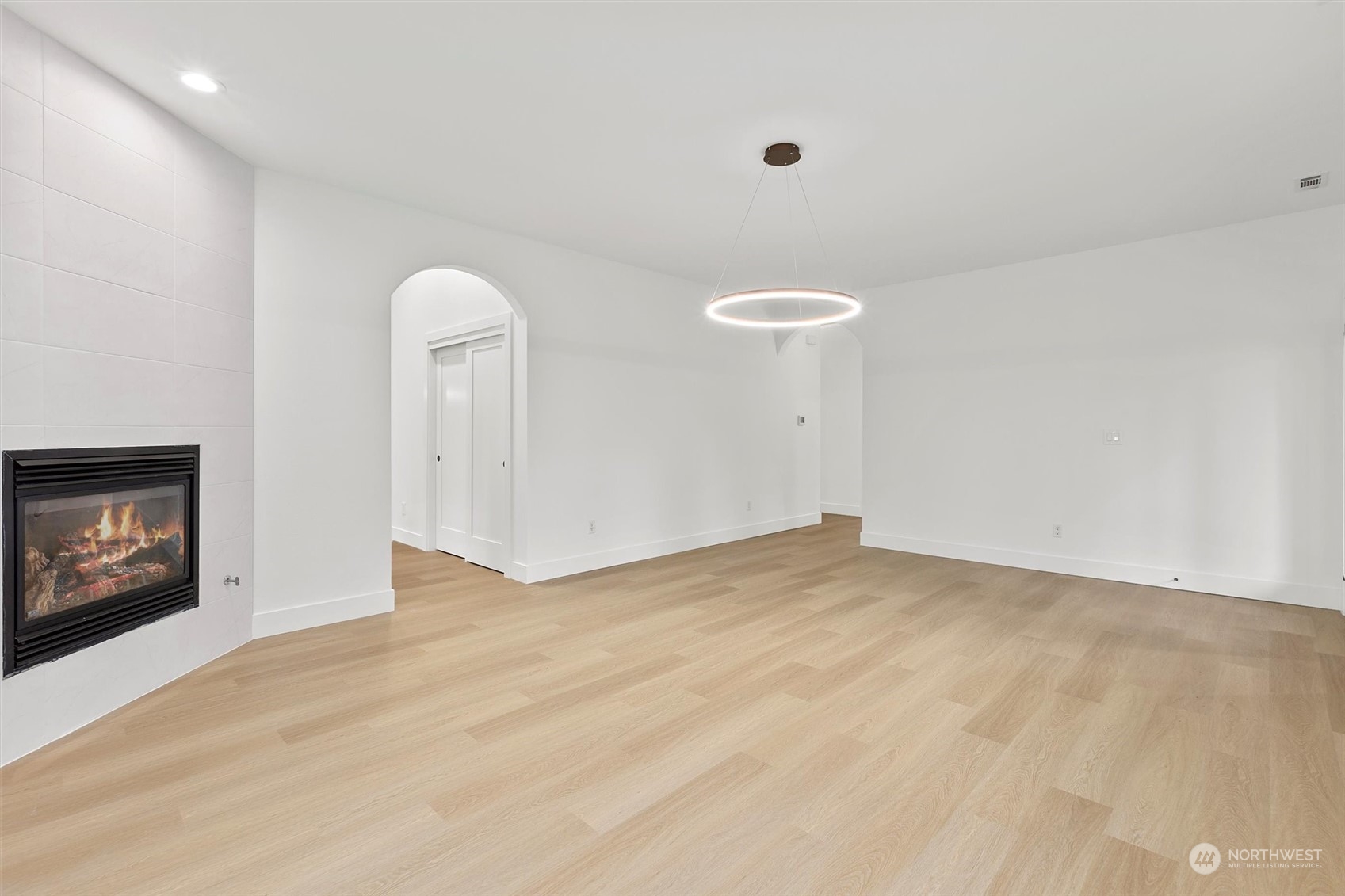 22713 1st Place West Bothell, WA 98021 - Photo 6 of 29 a view of an empty room with a fireplace and a window
