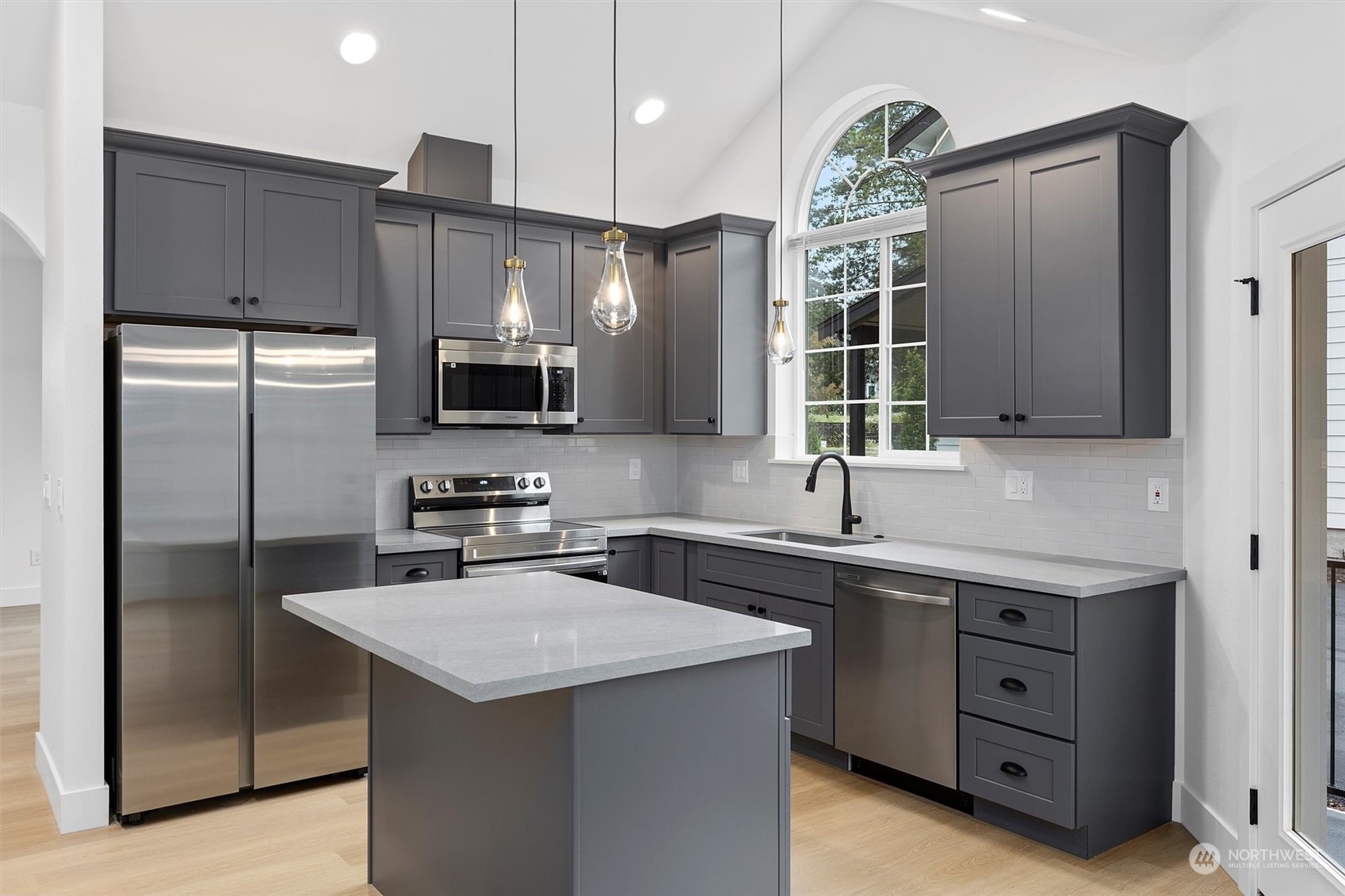 22713 1st Place West Bothell, WA 98021 - Photo 7 of 29 a kitchen with a sink a microwave a refrigerator and cabinets