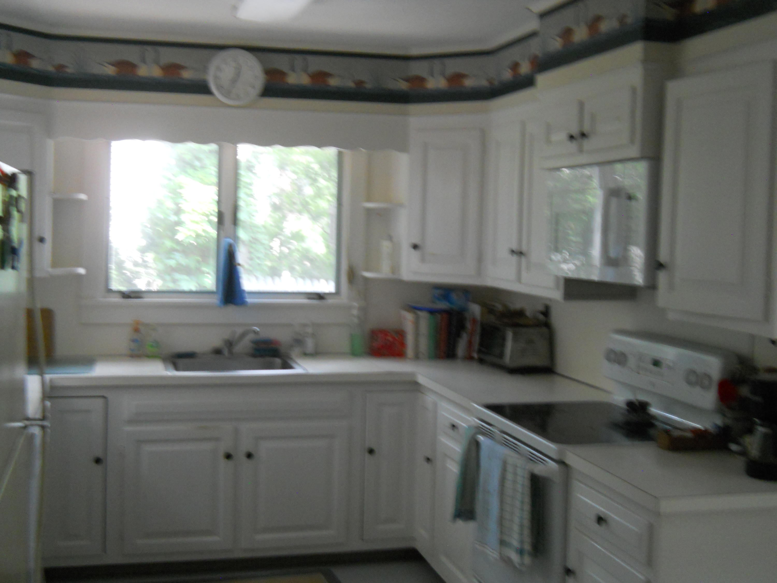 87 Eel River Road Osterville, MA 02655 - Photo 21 of 29 a kitchen with a sink stove and cabinets