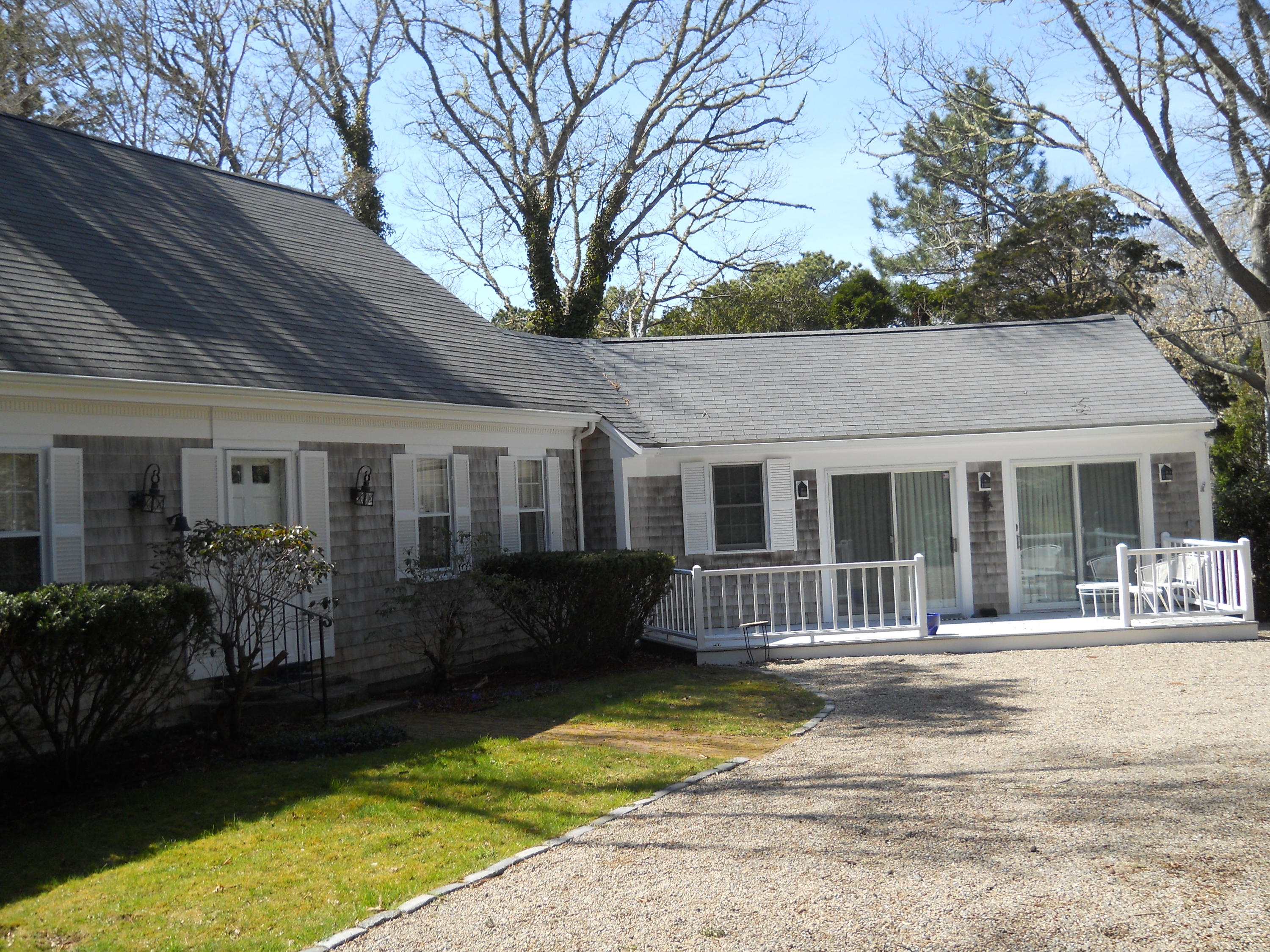 87 Eel River Road Osterville, MA 02655 - Photo 4 of 29 a front view of a house with a garden