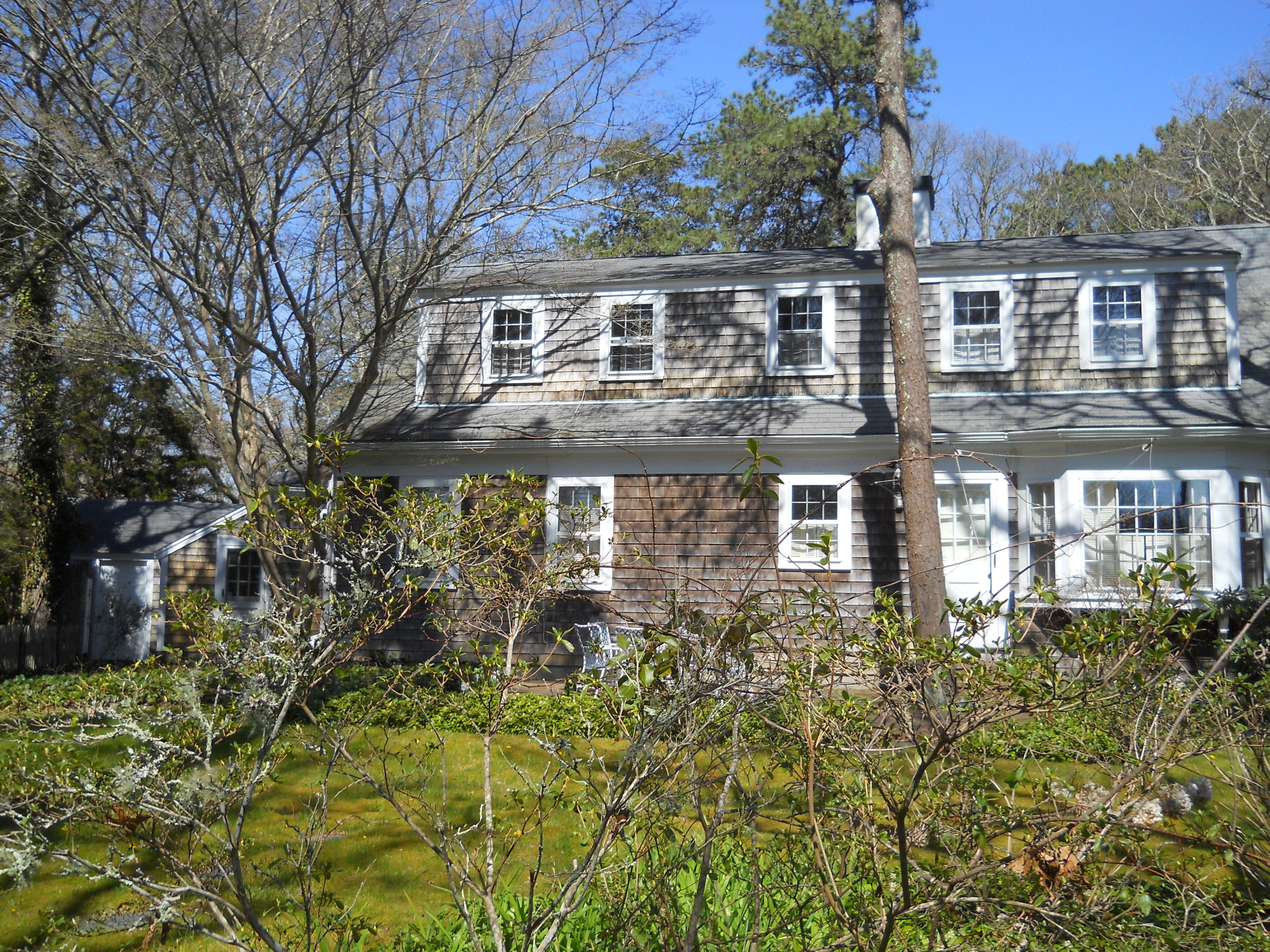 87 Eel River Road Osterville, MA 02655 - Photo 7 of 29 a front view of a house with a garden