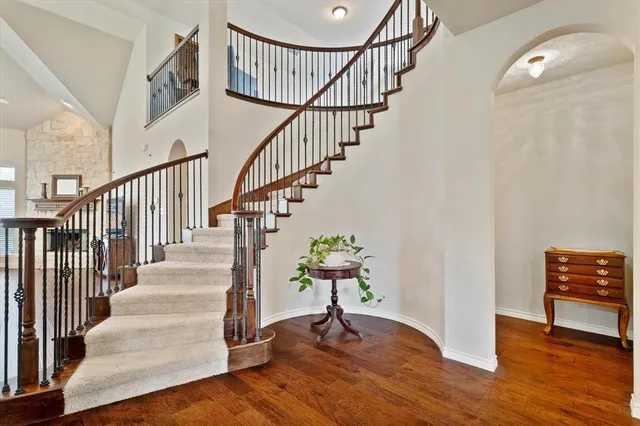 a view of entryway and hall with wooden floor