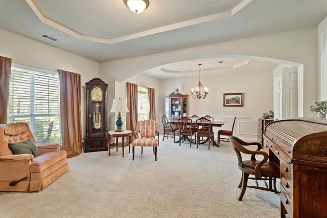a view of a dining room with furniture and window
