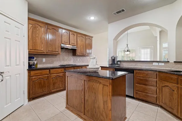 a kitchen with stainless steel appliances granite countertop a stove sink and cabinets