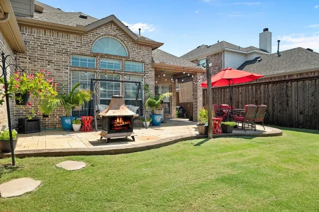 a view of a house with backyard porch and sitting area