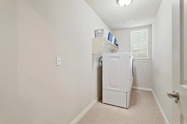 a spacious bedroom with a bed and a chandelier