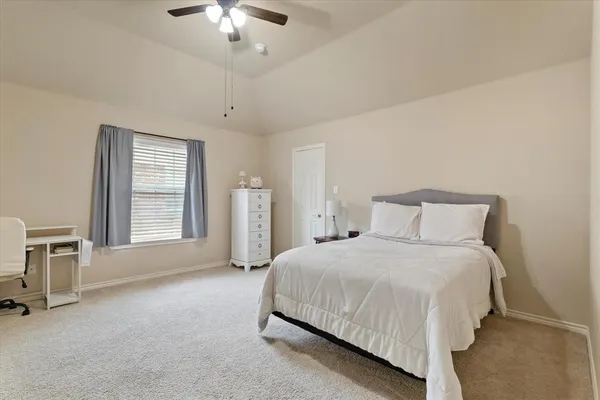 a bedroom with bed and a window