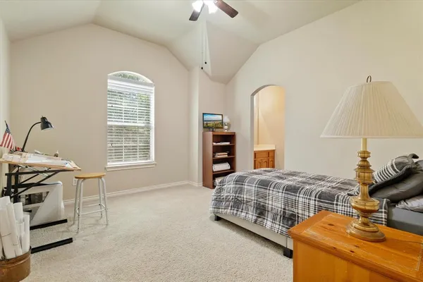 a bedroom with bed and a chandelier