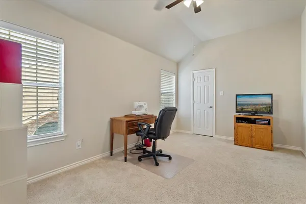 a view of a livingroom with furniture and a large window