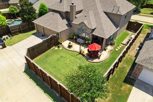 an aerial view of a house with a garden and swimming pool