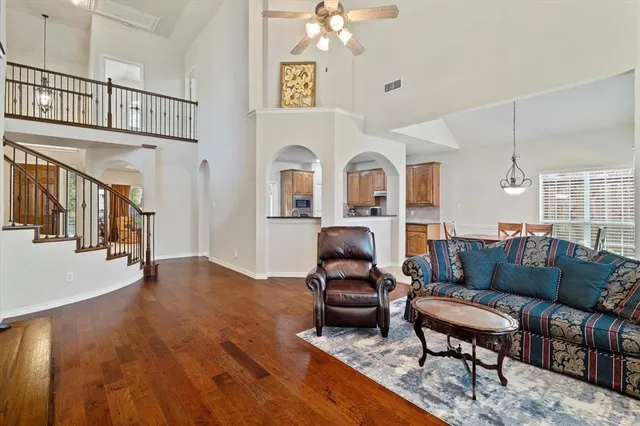 a living room with furniture and a chandelier