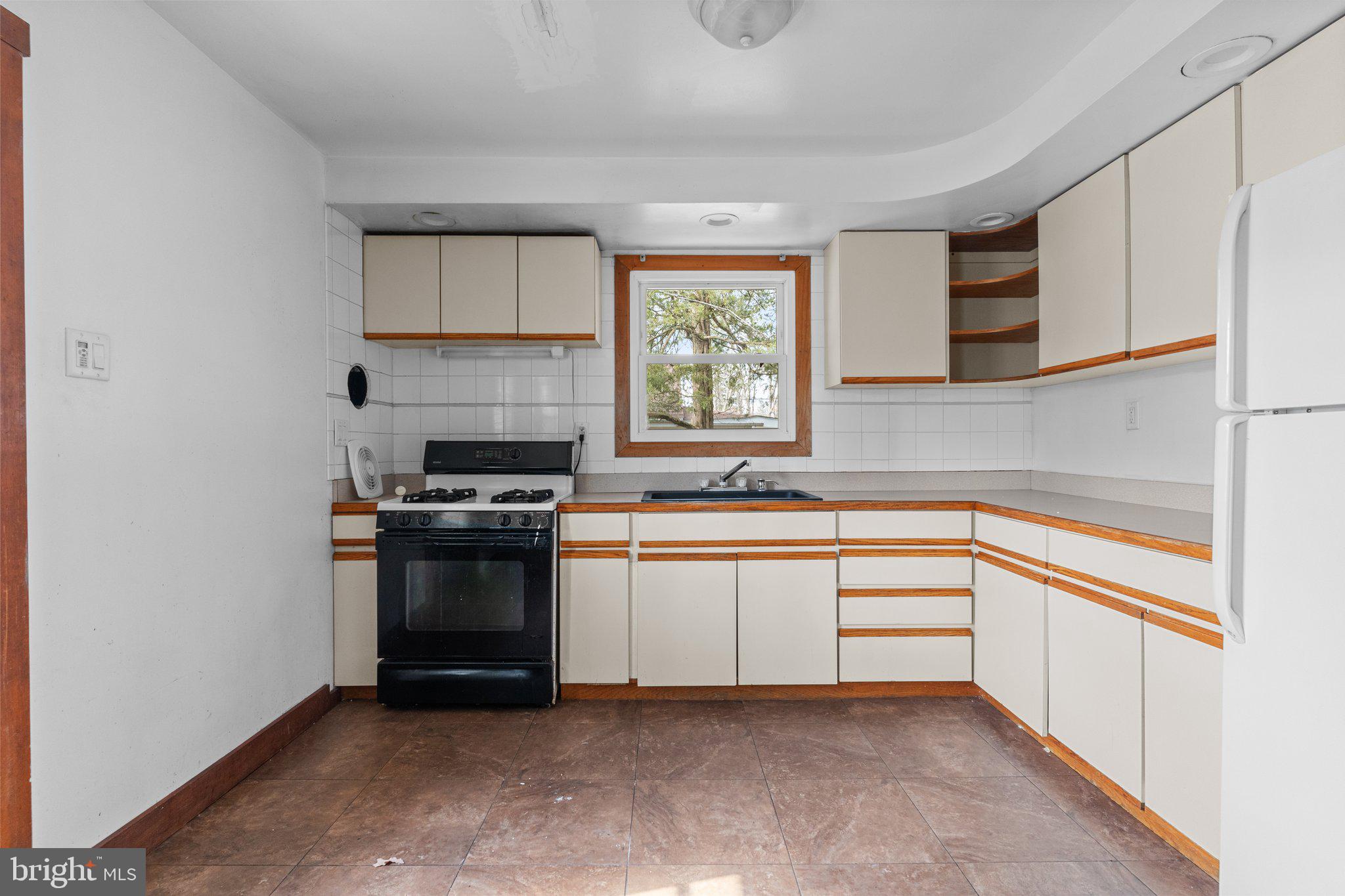 52 East 9th Avenue Pine Hill, NJ 08021 - Photo 12 of 25 a kitchen with stainless steel appliances granite countertop a stove and a sink