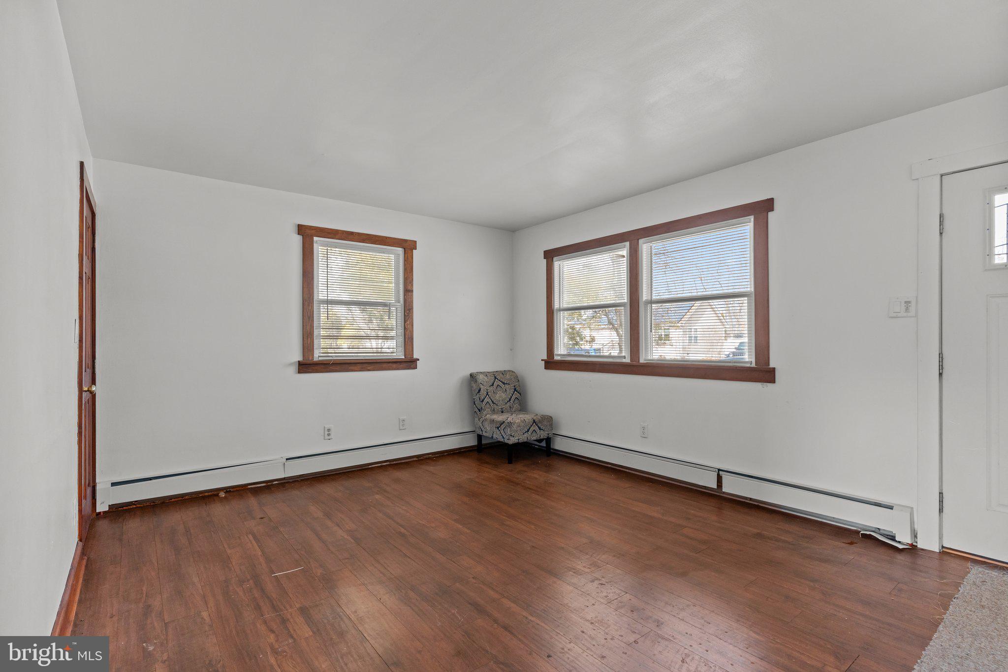 52 East 9th Avenue Pine Hill, NJ 08021 - Photo 6 of 25 wooden floor in an empty room with a window