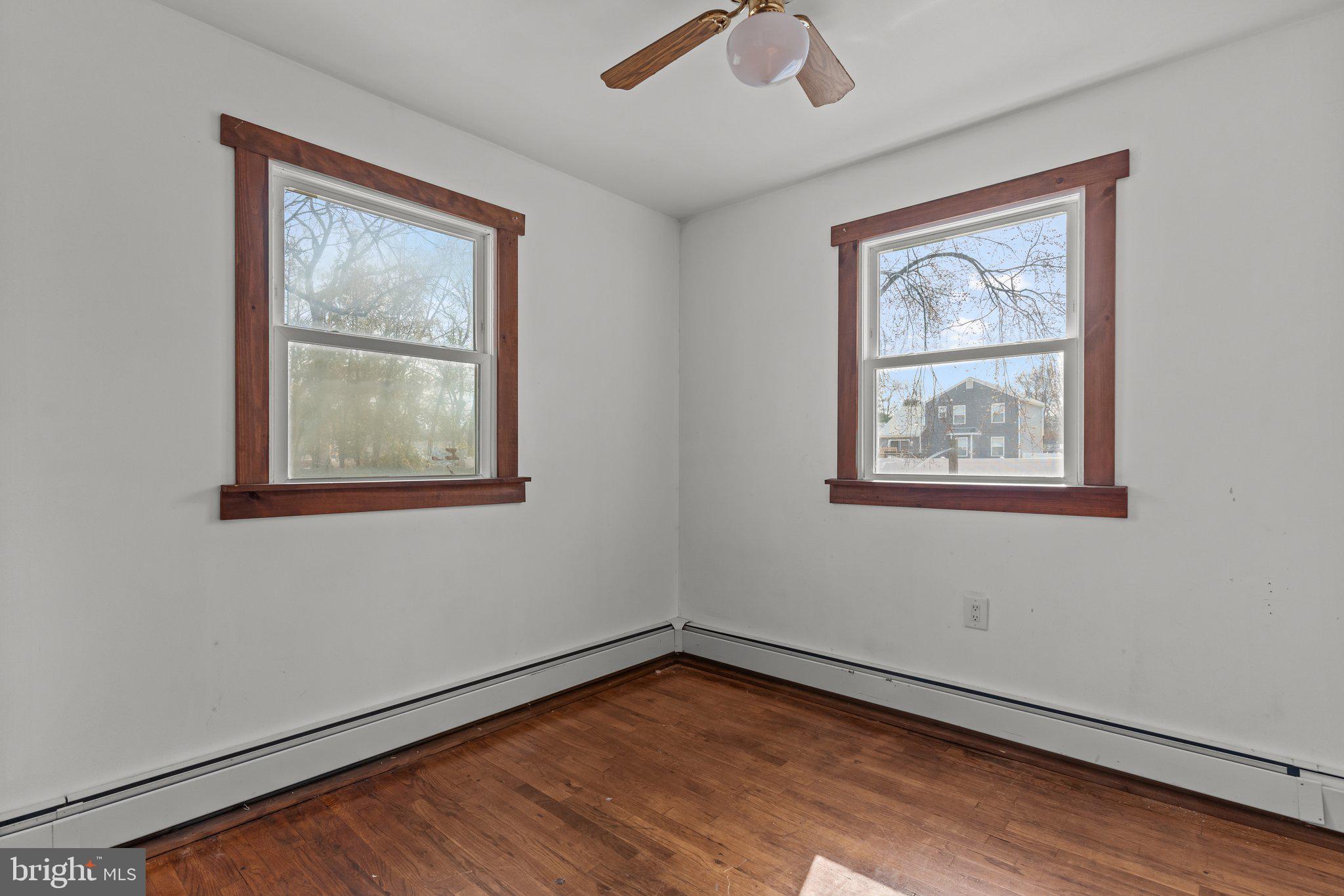 52 East 9th Avenue Pine Hill, NJ 08021 - Photo 7 of 25 a view of an empty room with a window and wooden floor