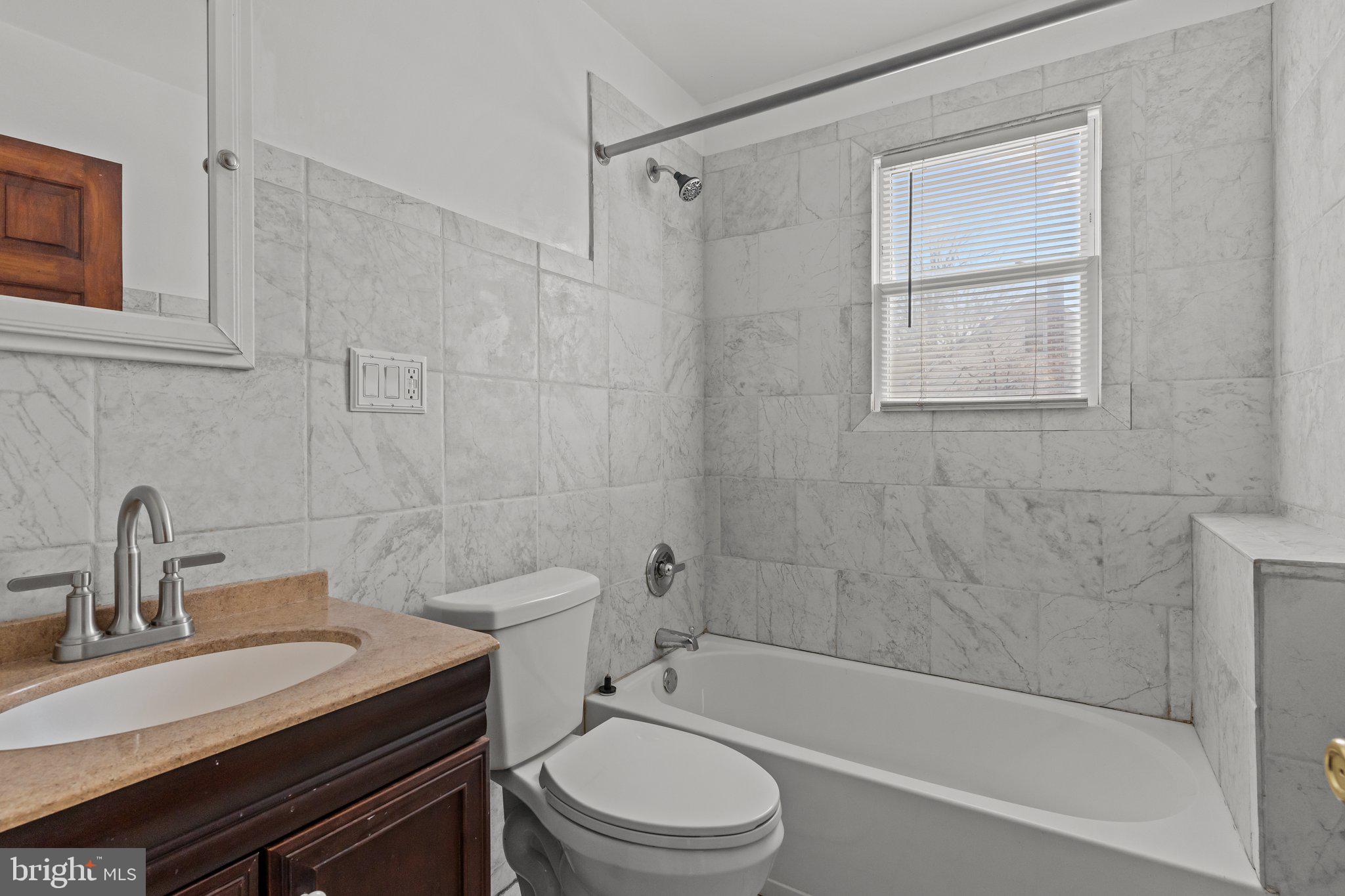 52 East 9th Avenue Pine Hill, NJ 08021 - Photo 8 of 25 a bathroom with a sink a toilet and a bathtub