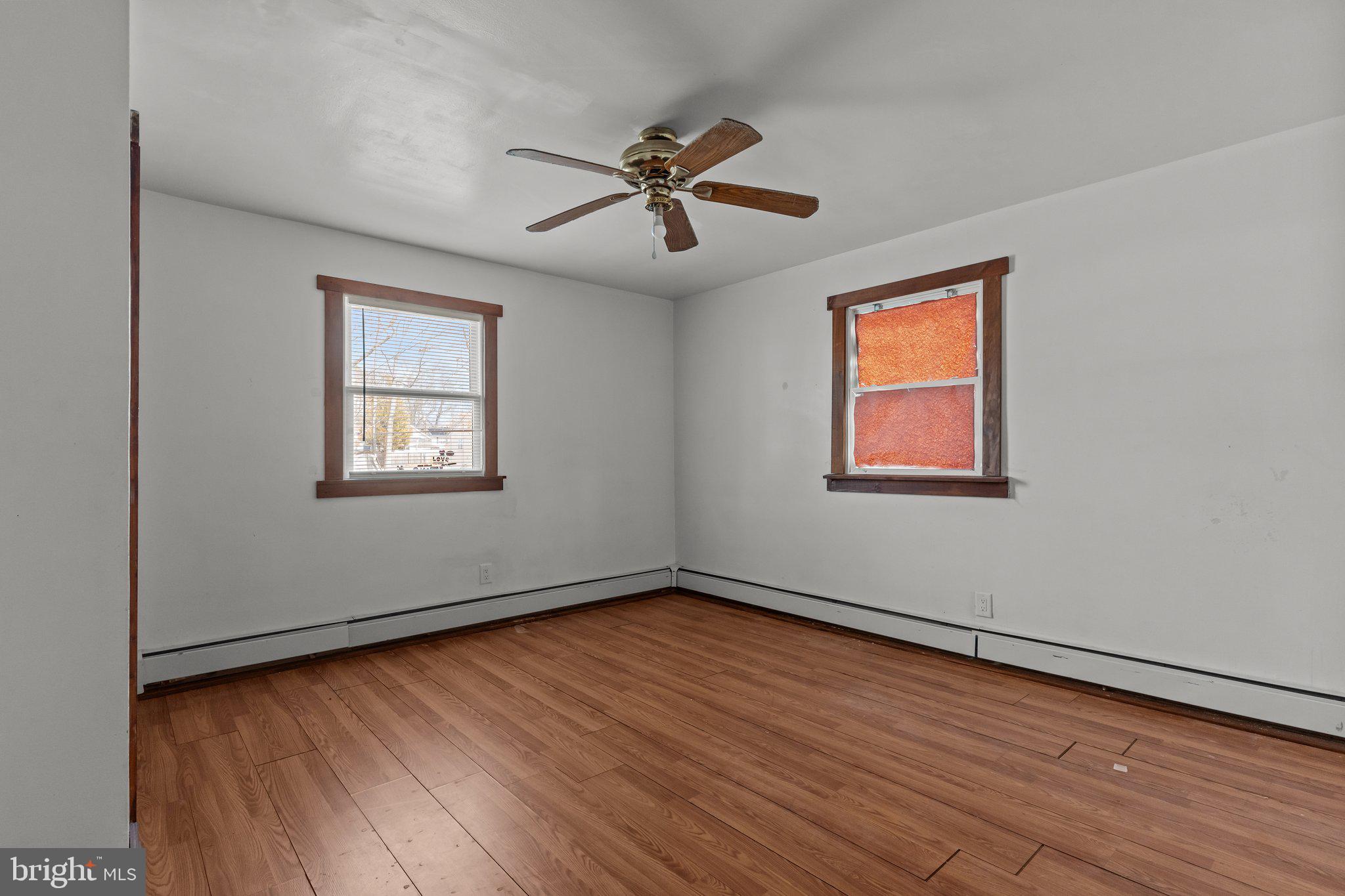 52 East 9th Avenue Pine Hill, NJ 08021 - Photo 9 of 25 wooden floor in an empty room with a window