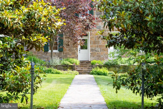 a living room with furniture a fireplace and a large window