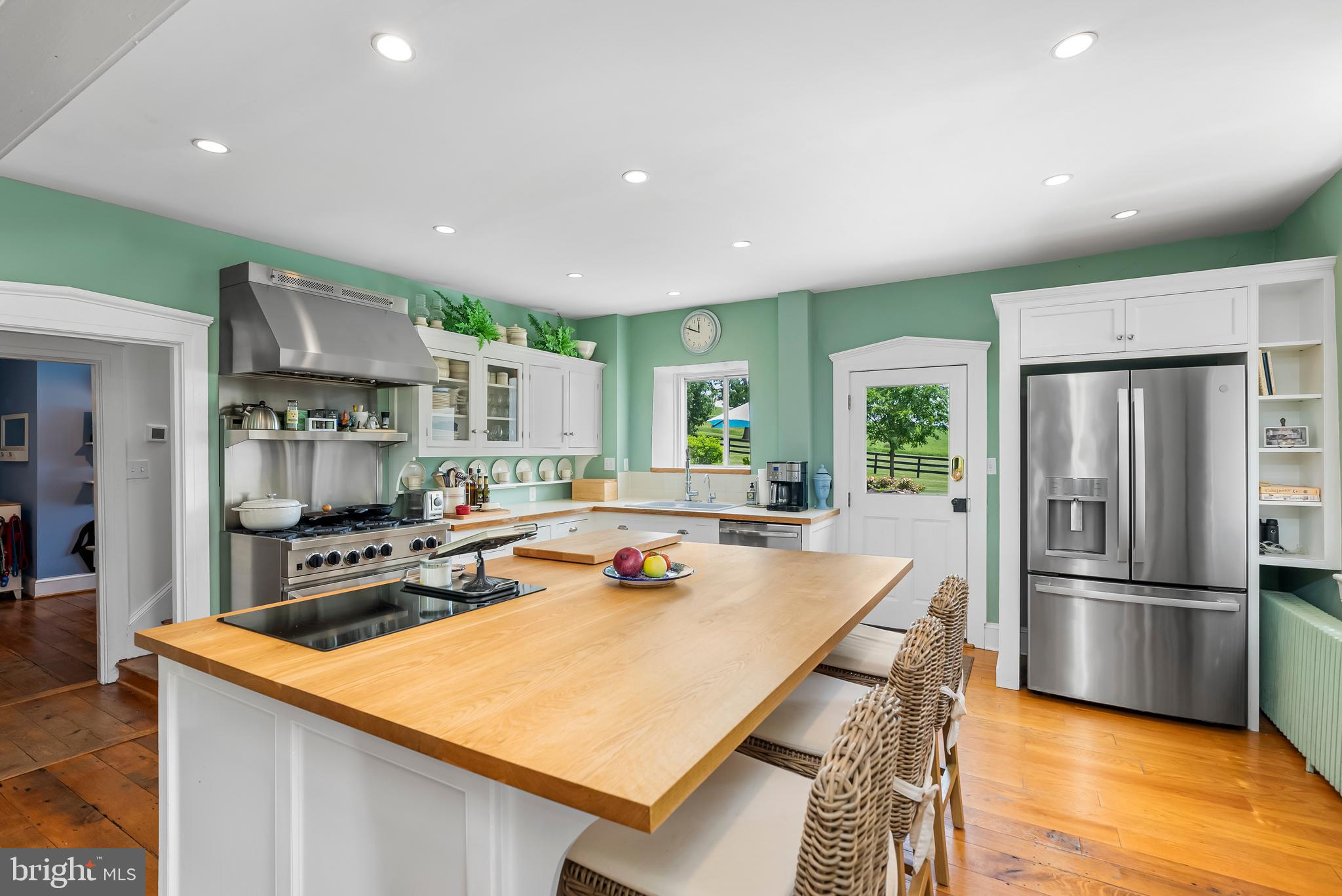 2810 Hoffman Mill Road Hampstead, MD 21074 - Photo 25 of 121 a kitchen with stainless steel appliances granite countertop a table chairs and a refrigerator
