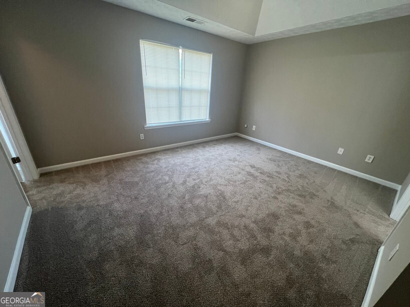 70 Princeton Way Covington, GA 30016 - Photo 13 of 32 an empty room with a empty space and window