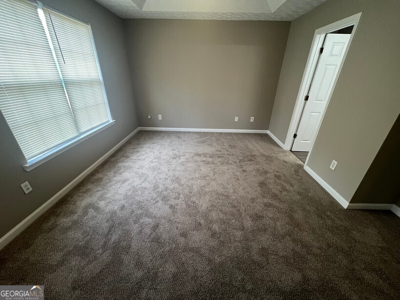 70 Princeton Way Covington, GA 30016 - Photo 14 of 32 an empty room with windows