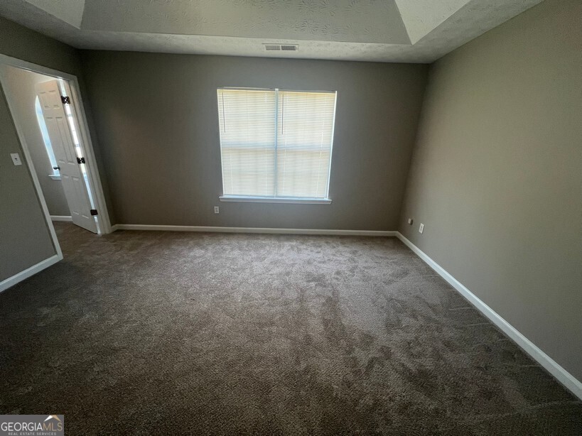 70 Princeton Way Covington, GA 30016 - Photo 15 of 32 an empty room with a window