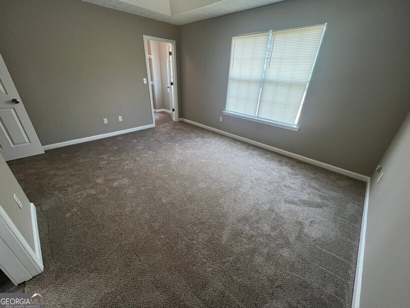 70 Princeton Way Covington, GA 30016 - Photo 17 of 32 an empty room with windows
