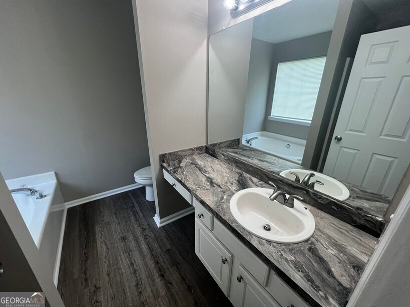 70 Princeton Way Covington, GA 30016 - Photo 19 of 32 a bathroom with a granite countertop sink toilet and a mirror