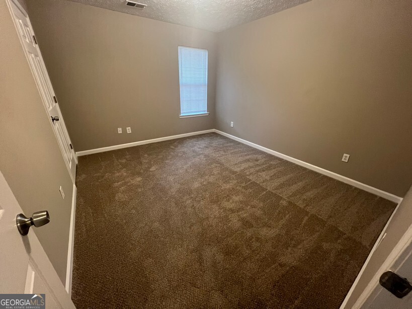 70 Princeton Way Covington, GA 30016 - Photo 21 of 32 an empty room with a door