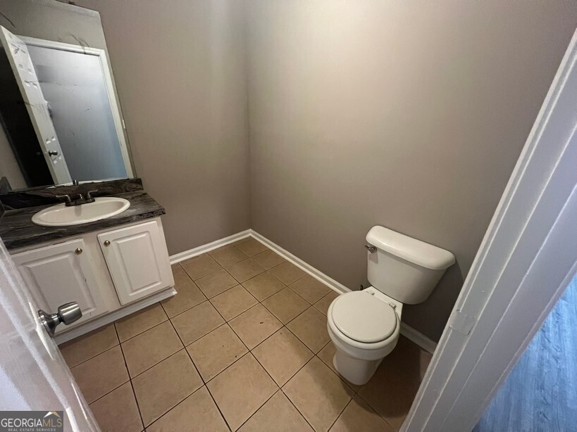 70 Princeton Way Covington, GA 30016 - Photo 30 of 32 a white toilet sitting next to a small sink