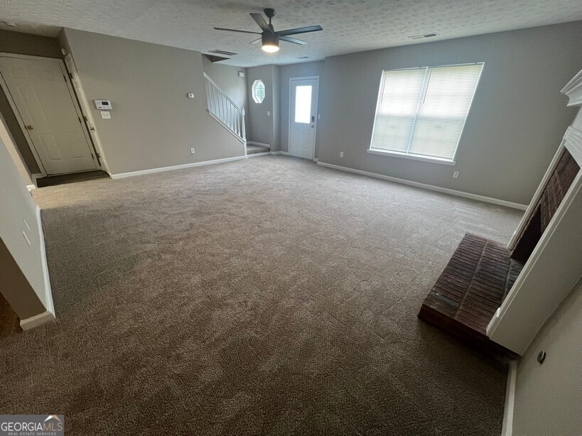 70 Princeton Way Covington, GA 30016 - Photo 5 of 32 an empty room with windows and fan
