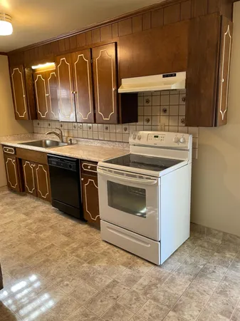 a kitchen with stainless steel appliances granite countertop a stove and a sink
