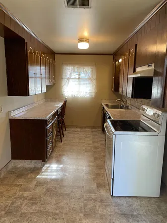 a kitchen with a stove and a refrigerator