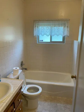 a bath room with a toilet and a bath tub