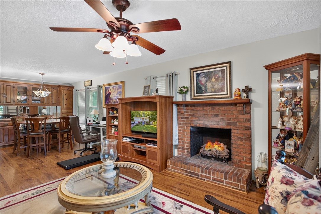 104 Laurel Lane Seneca, SC 29678 - Photo 4 of 36 A comforting fireplace hearth with rich wood flooring anchors this inviting living space.