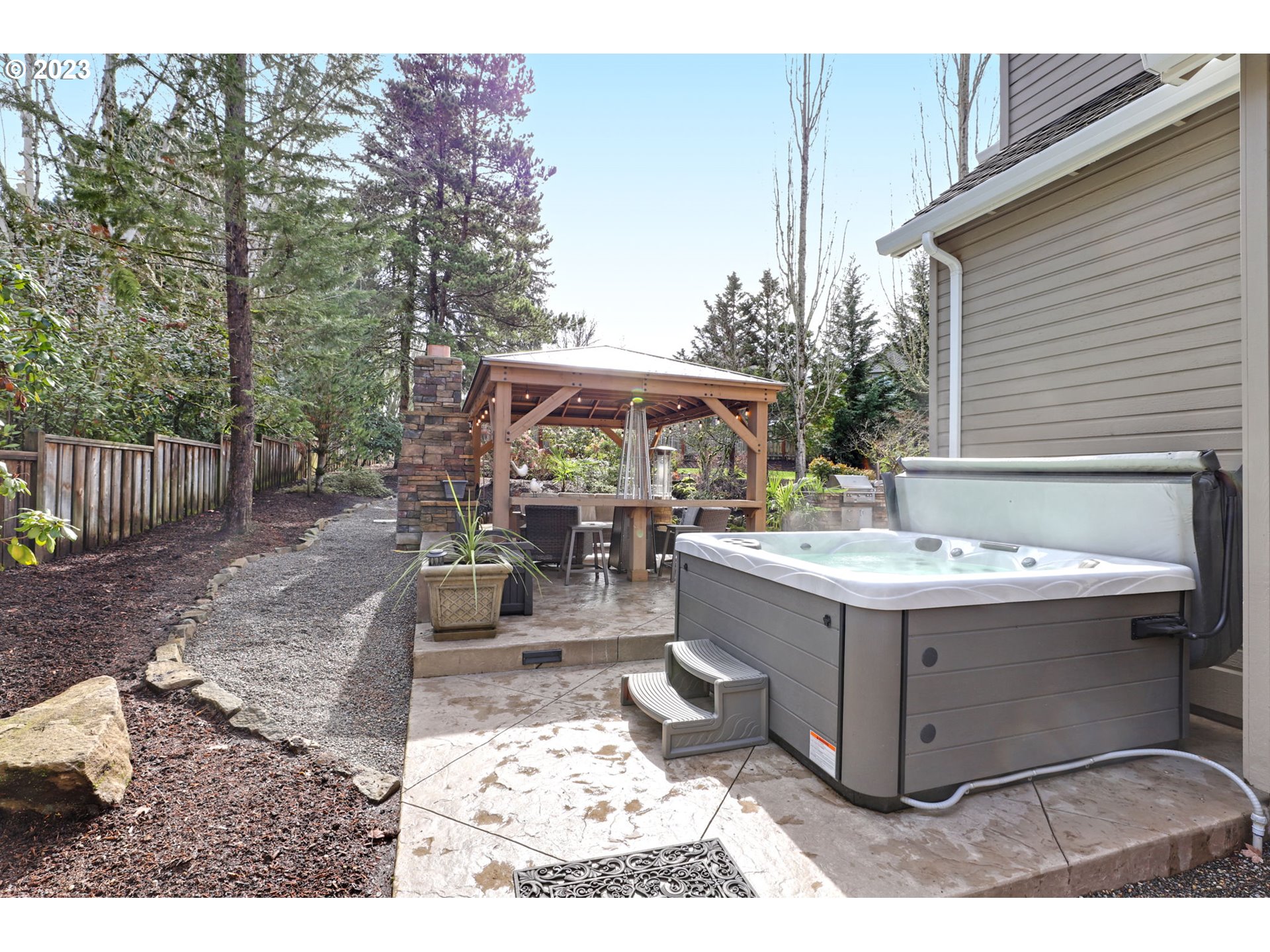 3566 Northwest Bronson Crest Loop Portland, OR 97229 - Photo 27 of 31 a view of a patio with table and chairs a barbeque with wooden fence