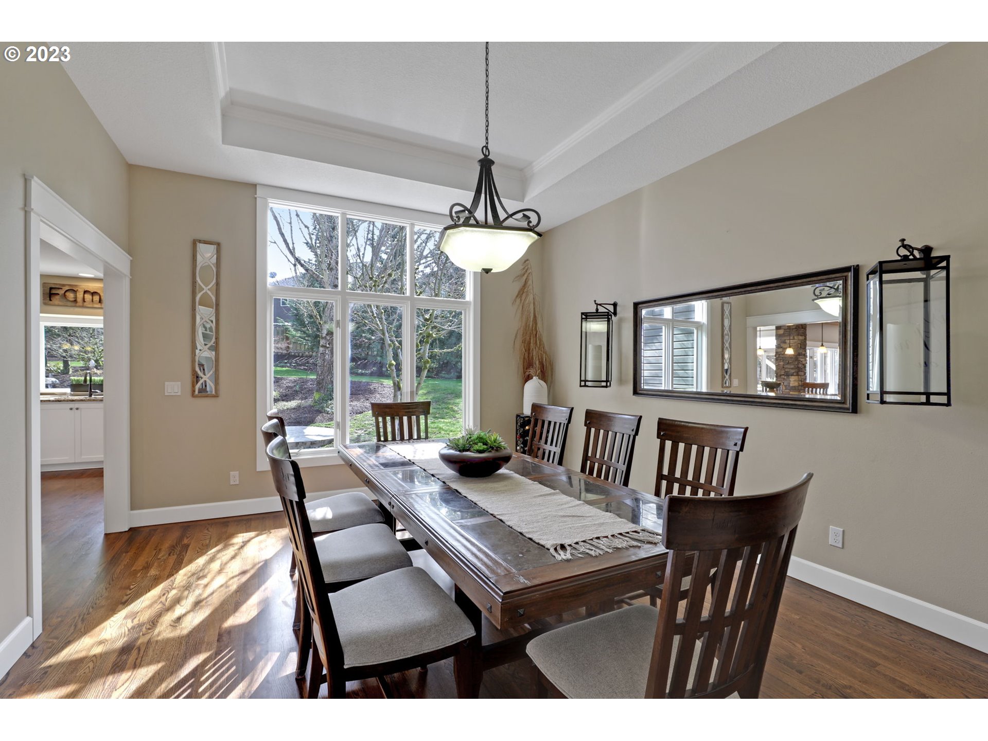 3566 Northwest Bronson Crest Loop Portland, OR 97229 - Photo 3 of 31 a view of a dining room with furniture large windows and wooden floor