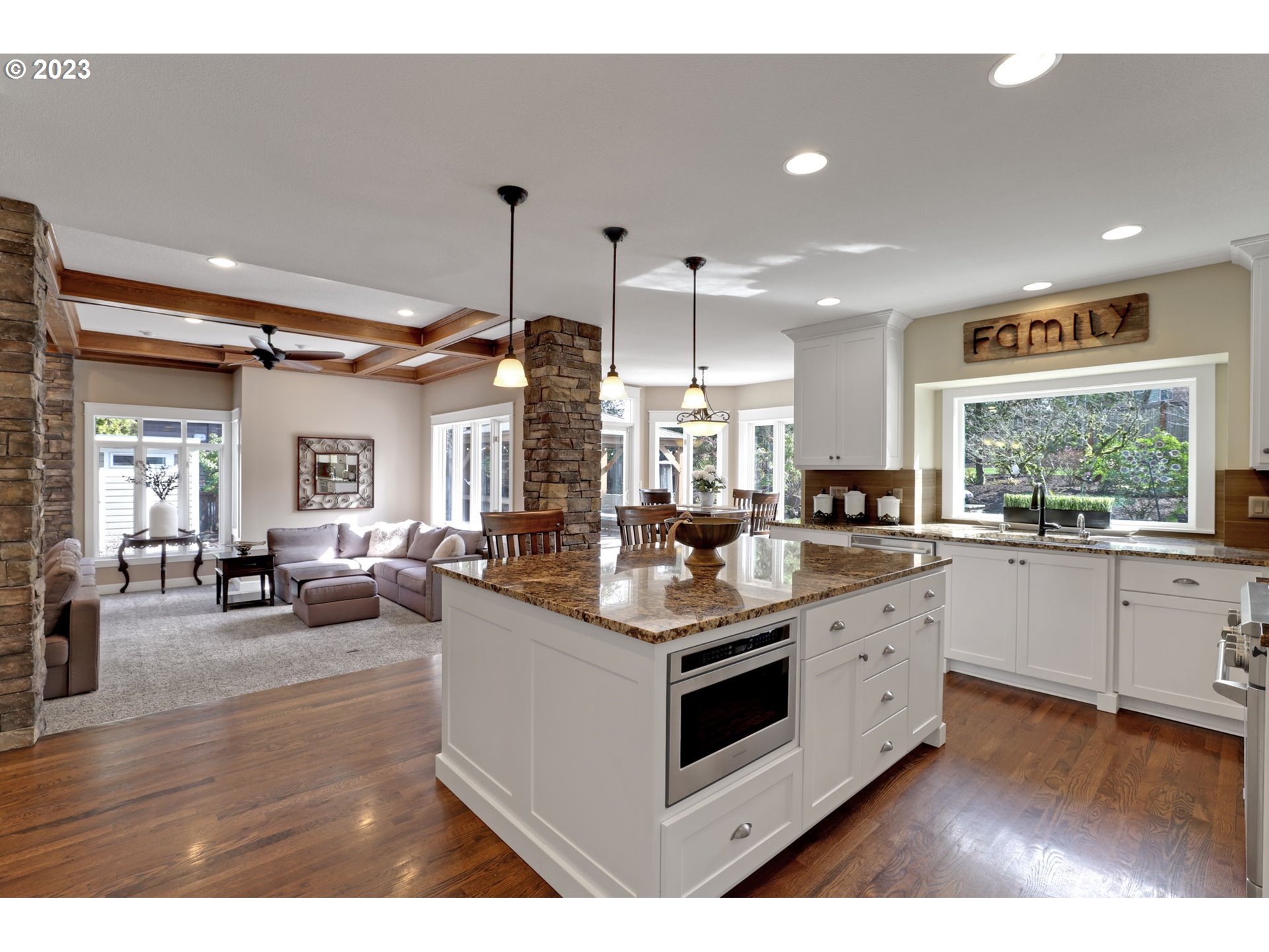 3566 Northwest Bronson Crest Loop Portland, OR 97229 - Photo 6 of 31 a kitchen with stainless steel appliances kitchen island granite countertop a stove and a sink