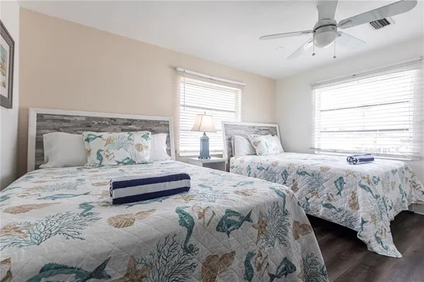 a bedroom with two beds and a window