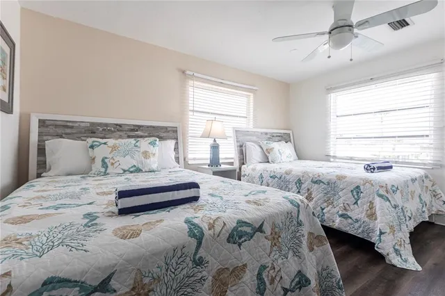 a bedroom with two beds and a window