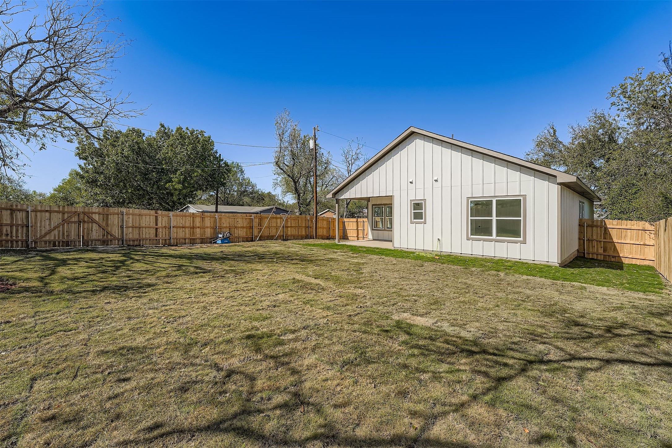 701 East 3rd Street Elgin, TX 78621 - Photo 32 of 35 Spacious fenced backyard with plenty of open green space, perfect for outdoor activities and entertaining