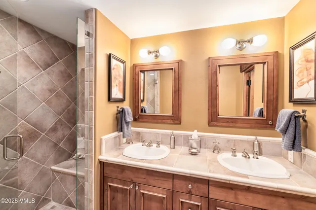 a bathroom with a sink a vanity and a mirror