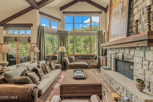 a living room with furniture a fireplace and a large window