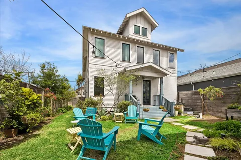 a front view of a house with garden and porch