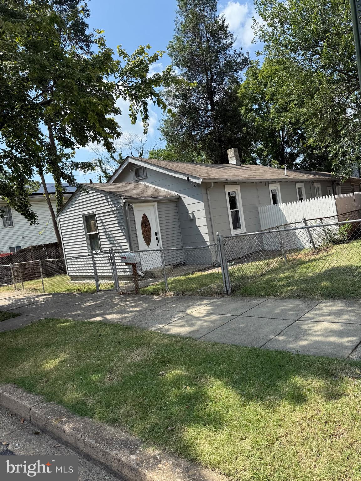 a backyard of a house with barbeque oven